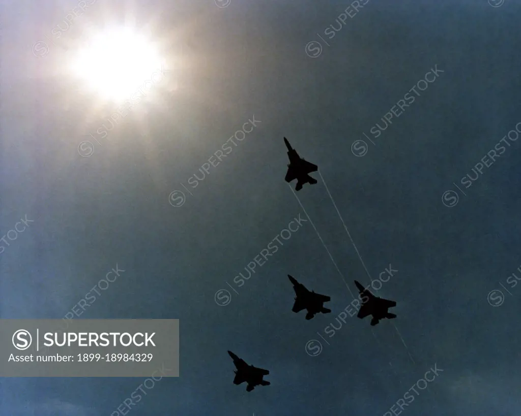 1980 - Four F-15 Eagle aircraft execute a Missing Man formation as they fly over the Pentagon during Memorial Day services.. 