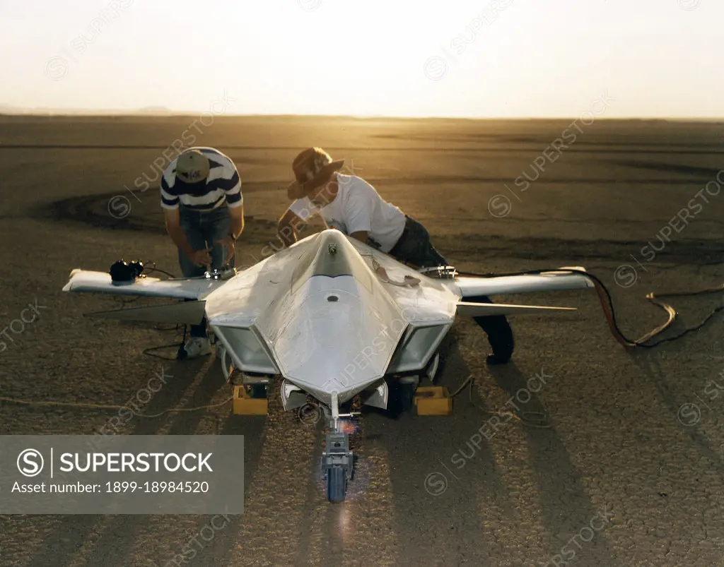 As the sun creeps above the horizon of Rogers Dry Lake at NASA's Dryden Flight Research Center, Edwards, California, technicians make final preparations for the first flight of the X-36 Tailless Fighter Agility Research Aircraft.. 