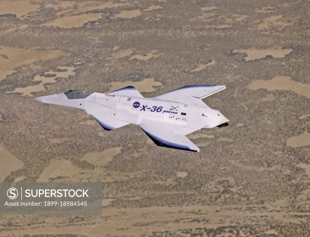 The unusual lines of the X-36 technology demonstrator contrast sharply with the desert floor as the remotely piloted aircraft scoots across the California desert at low altitude during a research flight on October 30, 1997.. 