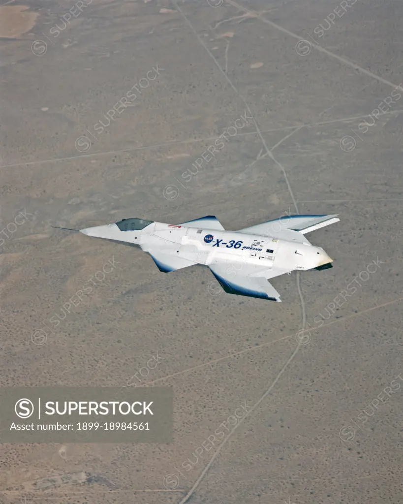 The tailless X-36 technology demonstrator research aircraft cruises over the California desert at low altitude during a 1997 research flight.. 