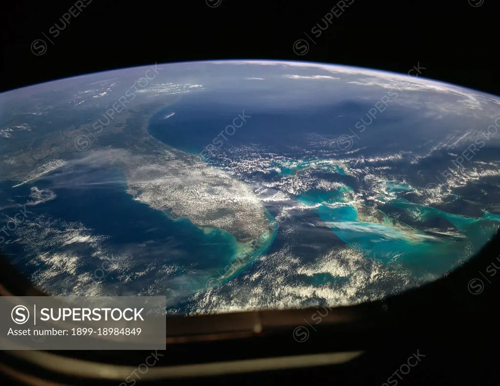 (26 April 1990) --- The Florida peninsula and smog over the northeastern U.S. coast are featured in this image photographed by a Space Shuttle Discovery crewmember during STS-31 mission. According to scientists, a mass of aerosol haze stretches across the top of the entire view. Meteorological, visibility and sulfate-content data showed that the haze was indeed industrial smog haze, rather than cloud. The air mass was transported west to east (left to right) around the north limb of a high pressure cell. It moved offshore for at least 1500 kilometers reaching the Atlantic islands of Bermuda. The leading edge of the haze mass can be detected far to the south, near the Bahamas--indicating that aerosols from the industrial Northeast were transported around the high, back directly toward the large population centers of Florida.. 