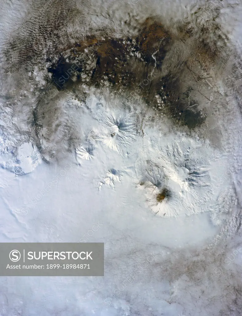 (28 April-6 May 1991) --- A large format frame of one of the USSR's volcanic complex (Kamchatka area) with the active volcano Klyuchevskaya (Kloo-chevs'-ska-ya), 15,584 feet in elevation.  The last reported eruption of the volcano was on April 8, but an ash and steam plume extending to the south was observed by the STS-39 crew almost three weeks later. The south side of the volcano is dirty from the ash fall and landslide activity.  The summit is clearly visible, as is the debris flow from an earlier eruption.  Just north of the Kamchatka River is Shiveluch, a volcano which was active in early April.  There are more than 100 volcanic edifices recognized on Kamchatka, with 15 classified as active.. 