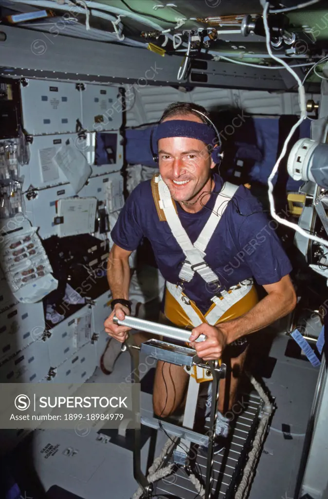  (2-11 Aug 1991) --- Astronaut G. David Low, STS-43 mission specialist, works out on a treadmill device which was used for medical testing on the nine-day flight.. 