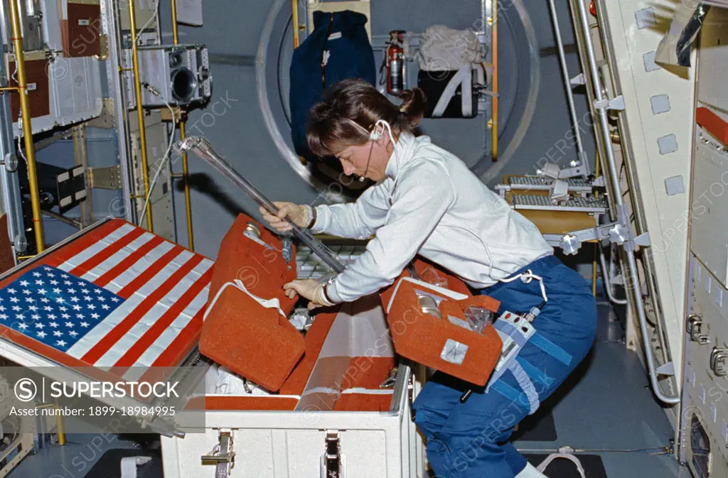 (25 June-9 July 1992) --- Astronaut Bonnie Dunbar, payload commander, unstows United States Microgravity Laboratory 1 (USML-1) experiment paraphernalia in early stages of the mission.. 