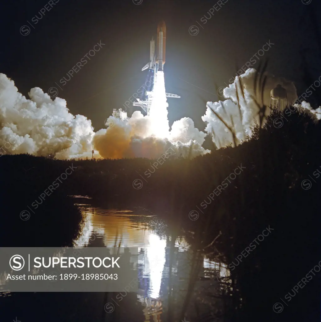 (24 Nov 1991) --- A wide shot of Atlantis' liftoff for STS-44 was recorded by a remote camera.  At 6:44 EST, Nov. 24, 1991, the spacecraft headed toward Earth orbit with a crew of six aboard.  The event is reflected in the KSC marsh waters.  Darkness accentuates the diamond shock effect from the three main engines.. 