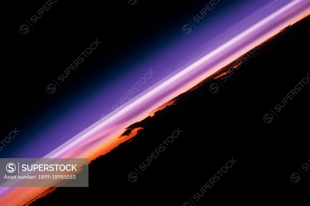 (12 - 20 Sept 1992) --- The colors in this photograph provide insight into the relative density of the atmosphere.  The crew members had many opportunities to witness sunrises and sunsets, considering they orbit the Earth every 90 minutes, but few, they said, compared to this scene.  It captures the silhouette of several mature thunderstorms with their cirrus anvil tops spreading out against the tropopause (the top of the lowest layer of Earth's atmosphere) at sunset.  The lowest layer (troposphere) is the densest and refracts light at the red end of the visible spectrum (7,400 Angstroms), while the blues (4,000 Angstroms) are separated in the least dense portion of the atmosphere (middle and upper atmosphere, or stratosphere and mesosphere).  Several layers of blue can be seen.  . 