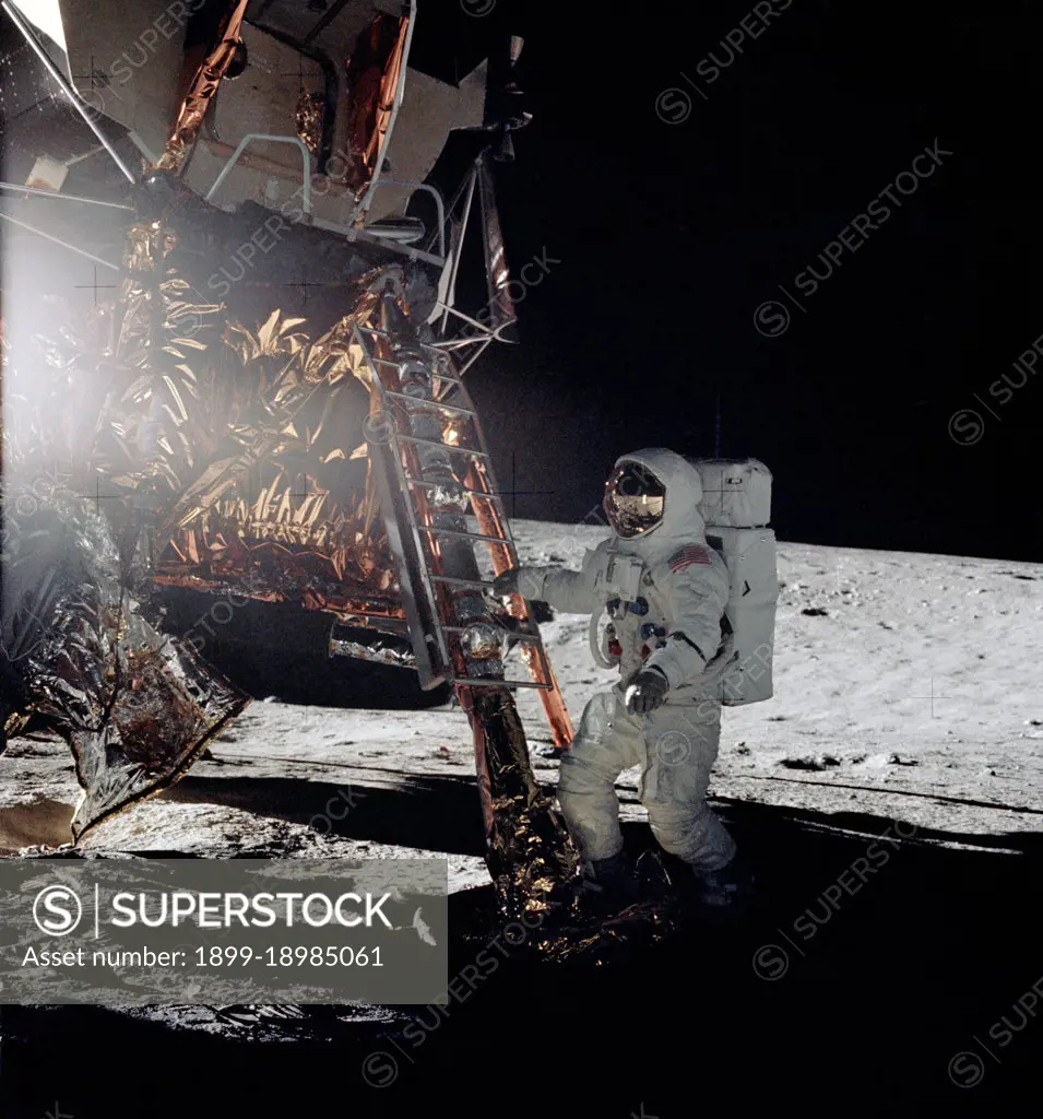 Astronaut Alan L. Bean, lunar module pilot for the Apollo 12 lunar landing mission, steps from the ladder of the Lunar Module to join astronaut Charles Conrad Jr., commander, in extravehicular activity on Nov. 19, 1969.. 