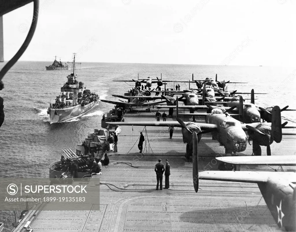 USA/Japan: Some of the B-25 Mitchell Bombers of the Doolittle Raiders crowd the rear deck of the USS Hornet with two escort vessels following close in the background, north Pacific, April 1942