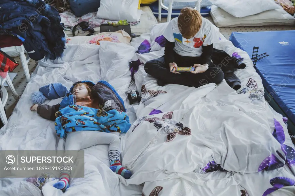 Ukranian refugees at a temporary shelter created inside the big ballroom and reception hall of the luxurious hotel Mandachi, in the Romanian town of Suceava, around 30 minutes from the border between Ukraine and Romania