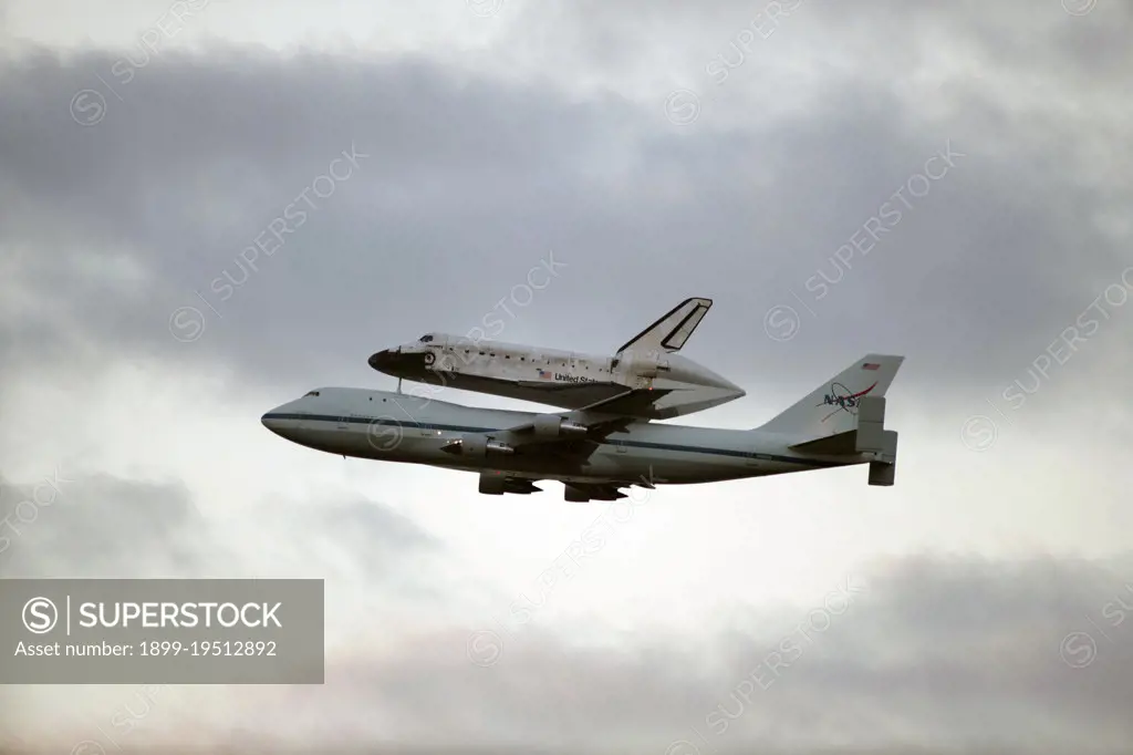 CAPE CANAVERAL, Fla. - Space shuttle Discovery, mounted to a Shuttle Carrier Aircraft, flies toward Cocoa Beach and Patrick Air Force Base after taking off from the Shuttle Landing Facility at NASA's Kennedy Space Center in Florida.