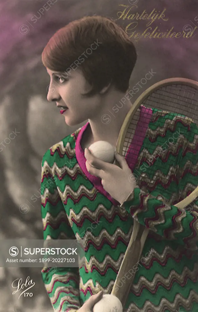 Woman with short hair & sweater with tennis racquet and ball. 