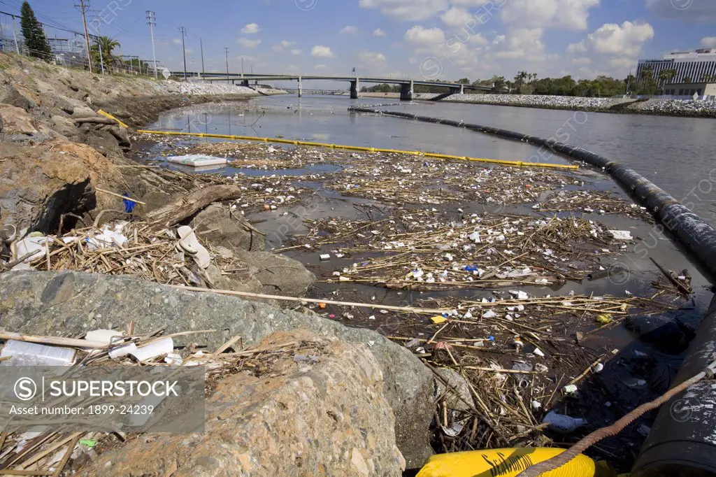 The Garbage boom on the Los Angeles River in Long Beach was built in 2001. Urban runoff carries an assortment of trash and debris from catch basins where a network of pipes and open channels create a pathway to the Ocean. The man made debris includes plastic bags and bottles, Styrofoam cups, cans, tires, and household furniture. After the first major storm of the season, the boom may collect over 50,000 pounds of trash. 