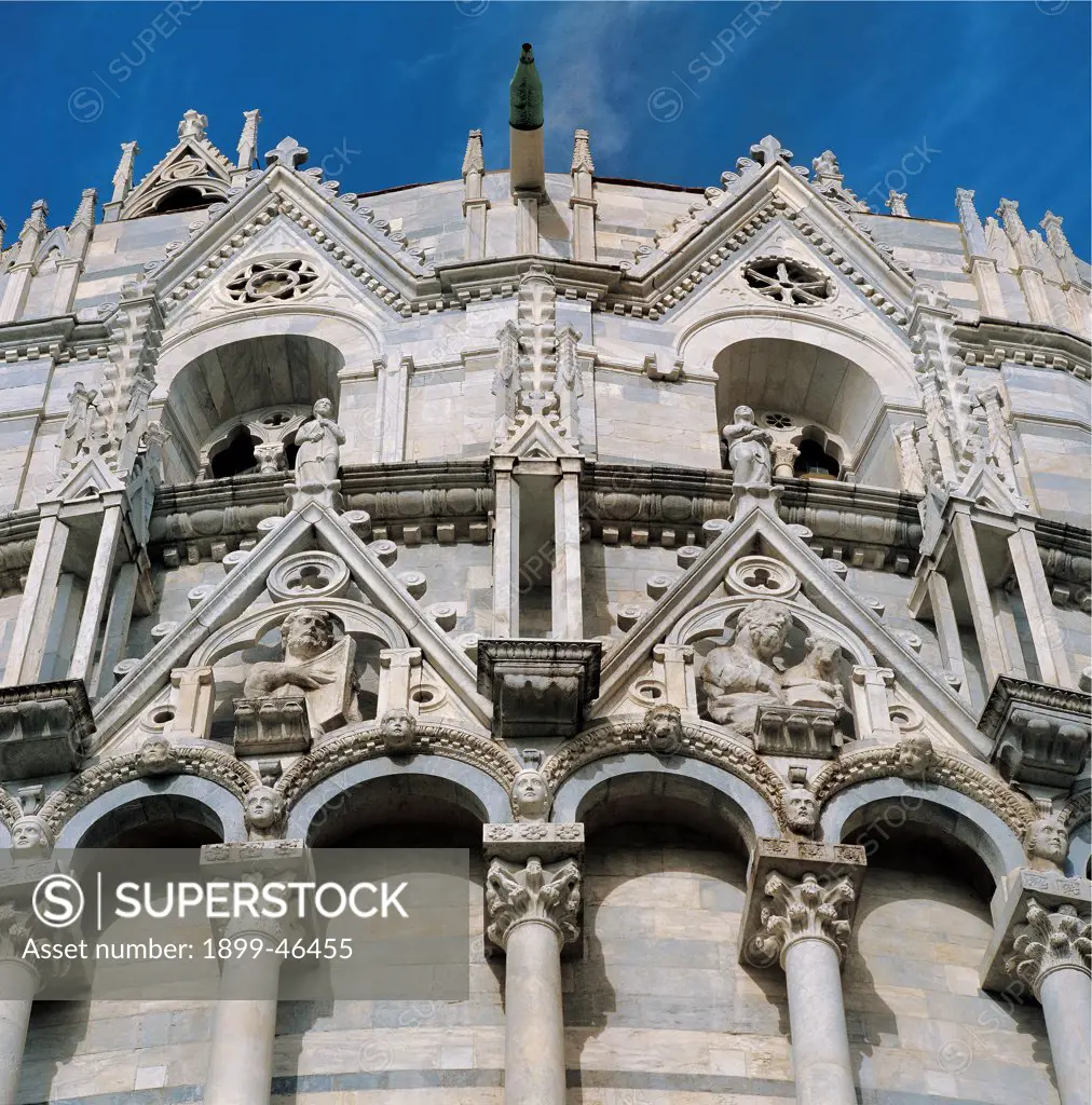 Baptistery of Pisa, by Diotisalvi, Nicola Pisano, 1152 - 1284, 12th Century, sandstone, marble. Italy: Tuscany: Pisa: Piazza dei Miracoli. Detail. Exterior baptistery second order loggia small open loggias arches small pillars crown pinnacles/spires cusped tabernacles cusp Rayonnant Gothic statues Evangelists