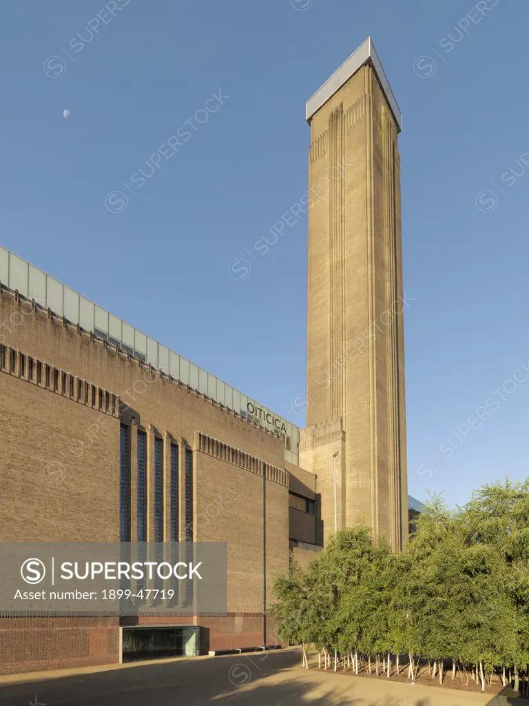 Tate Modern, by Herzog & de Meuron , Scott George Gilbert, 1995 - 2000, 20th Century, steel and reinforced concrete. Great Britain, London, Tate Modern. Detail. Facade garden. Museum Tate Modern thermoelectric power station: thermoelectric power plant large windows glasses chimney tower bricks London trees.