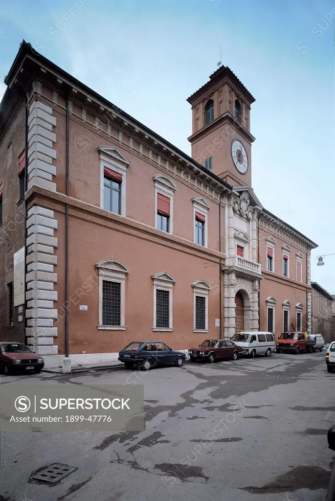 Ferrara, Palazzo Paradiso, by probably Balbi Alessandro, 1391, 16th Century, Unknow. Italy, Emilia Romagna, Ferrara, Palazzo Paradiso. Foreshortened side-view facade tower clock edge corner stones windows arch central doorway white cornices balcony wrought-iron grilles.