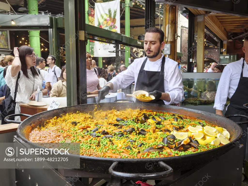 Spanish paella food stall at Borough Market, London, UK.