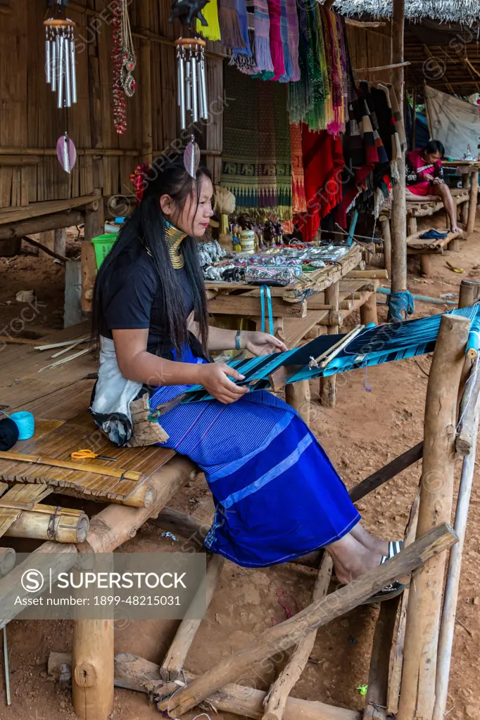 Tribal woman weaving scarves to be sold in the Long Neck Karen tribe (more properly called the Kayah Lahwi tribe) area of the Union of Hill Tribe Villages outside of Chiang Rai in the Nanglae District of Thailand.