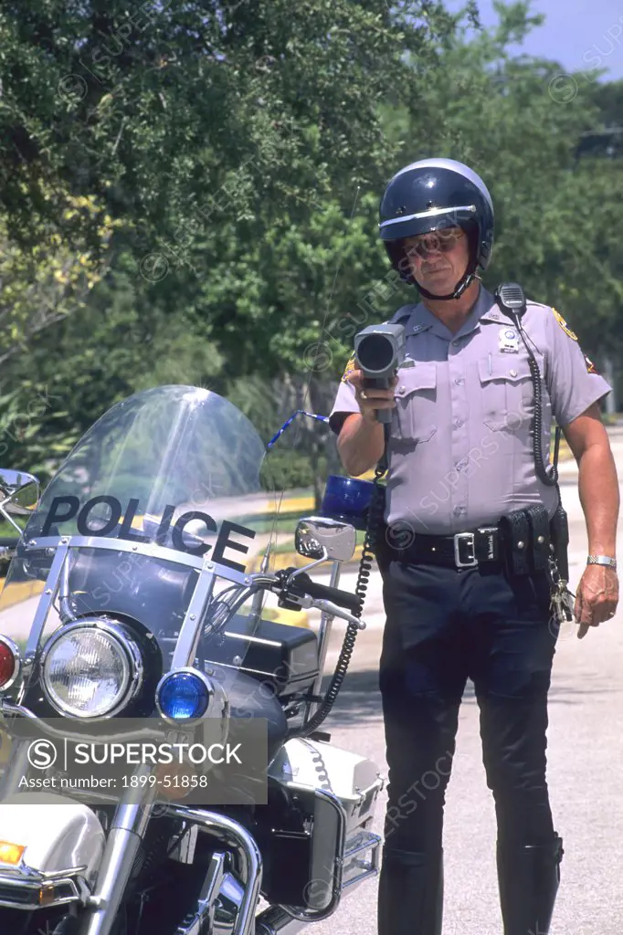 Police Officer Checking Speed With Radar Gun