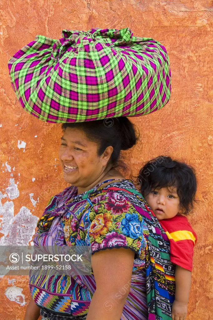 Guatemala, Antigua, Woman Carrying Baby On Back