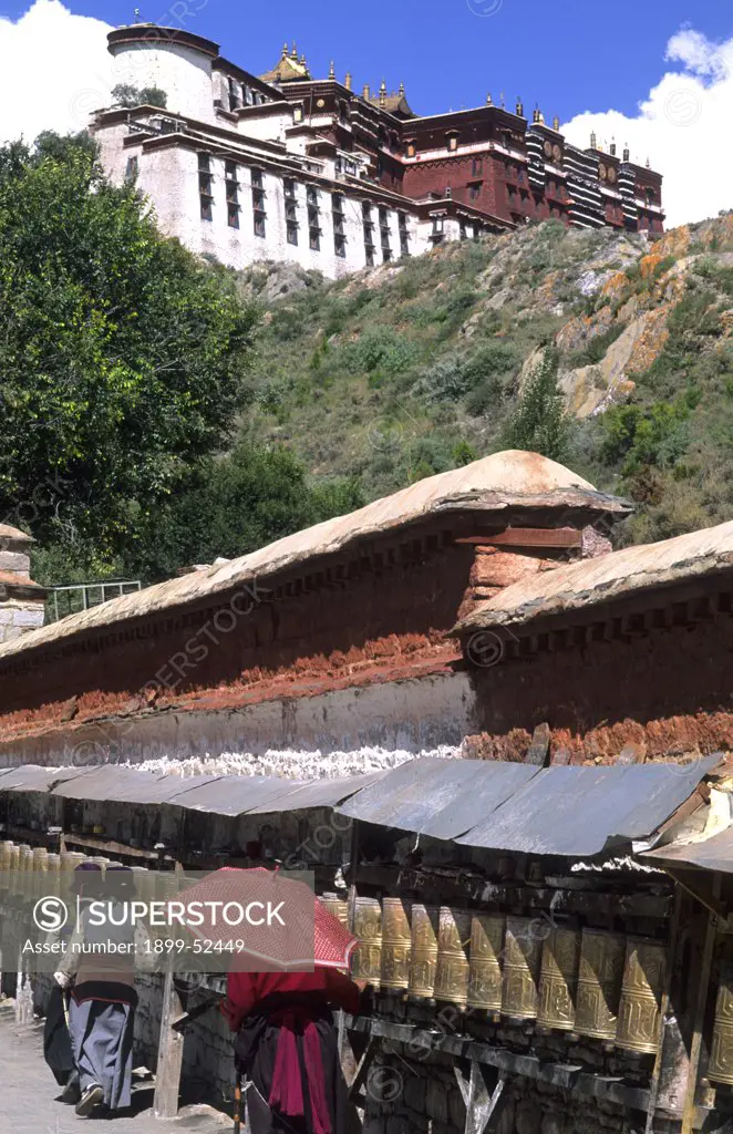 Potala Palace. Prayer Wheels In Front Of The Home Of The Dalai Lama In Capital City Of Lhasa, Tibet, China