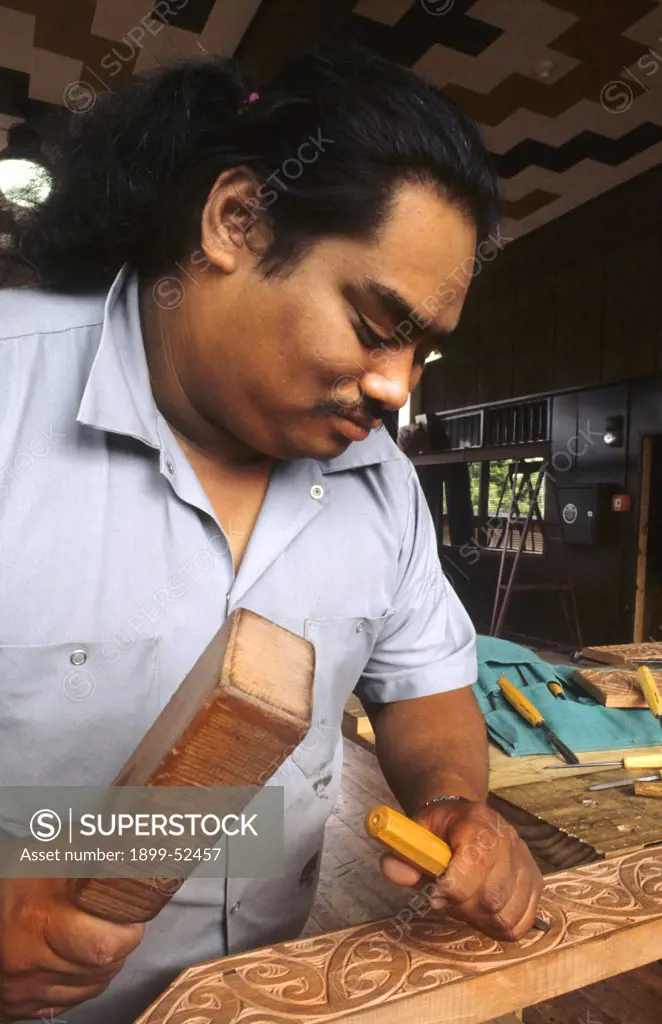 Maori Artist Carving Wood In His Studio At Rotorua, New Zealand