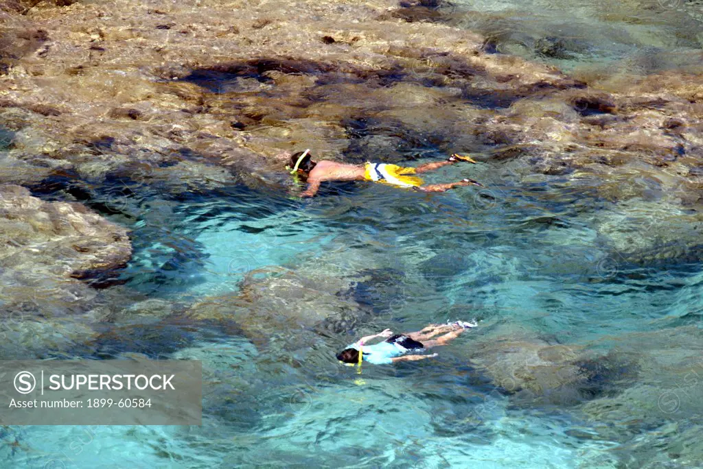 Oahu, Hawaii - People Snorkeling At The Hanauma Bay Coral Reef On The South East Shore Of Oahu, Hawaii.