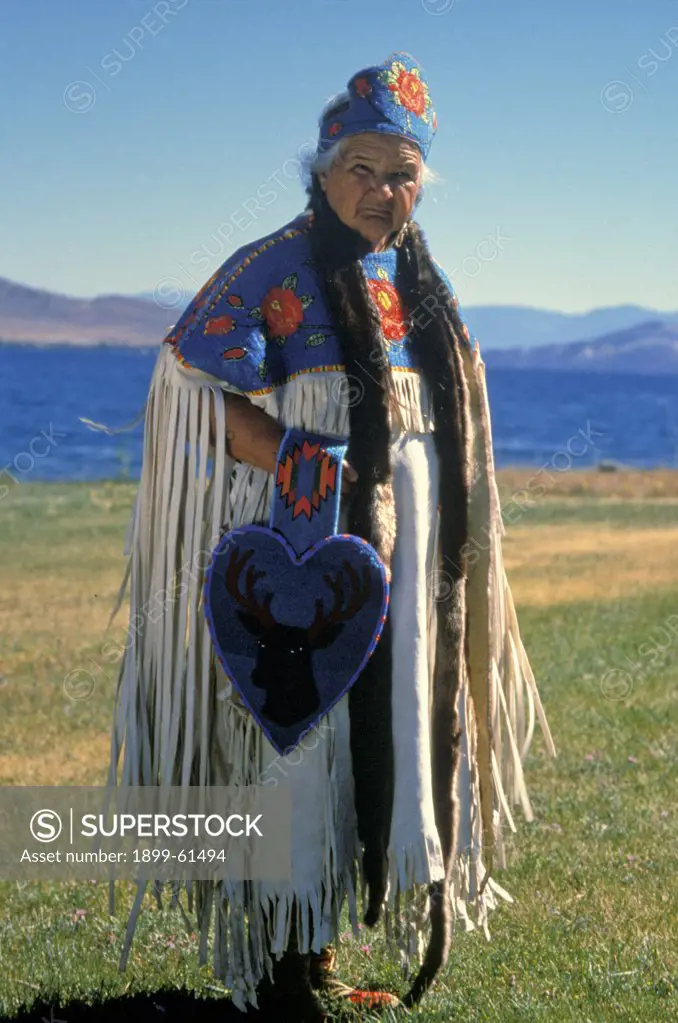 Montana, Flathead Lake. Standing Portrait Of Flathead Indian With Her Beadwork.