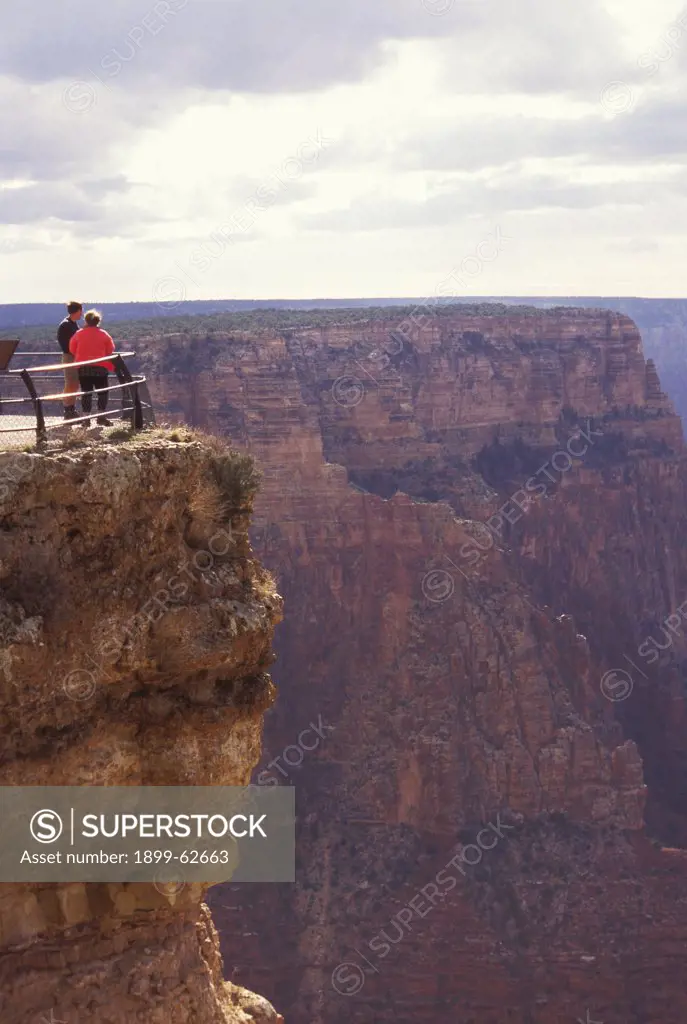 Arizona, Grand Canyon. Couple Standing By Railing At Scenic Overlook