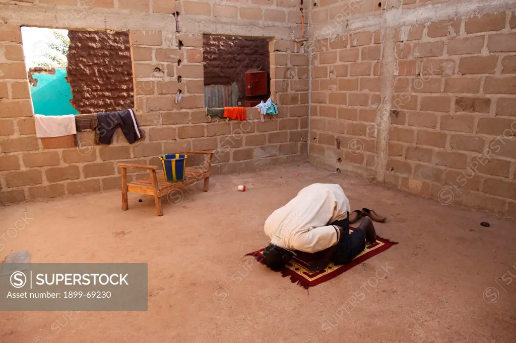 African man praying at home.