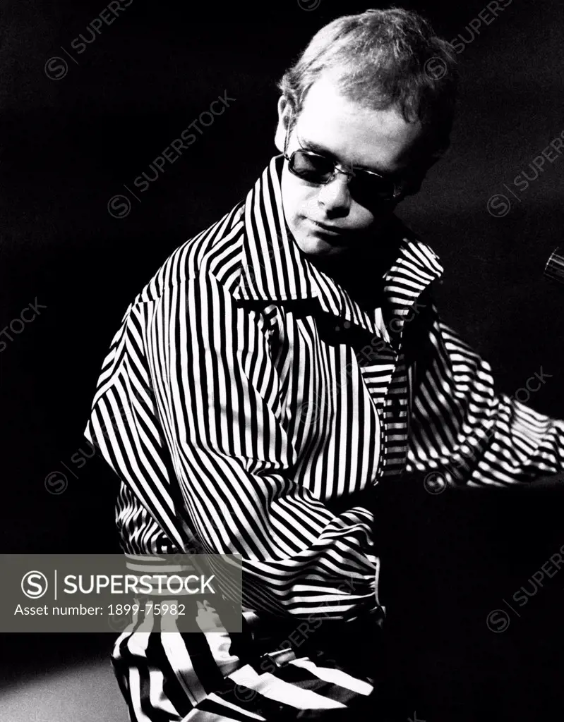 British singer, songwriter and musician Elton John (Reginald Kenneth Dwight)  playing piano. Rome, 1973.