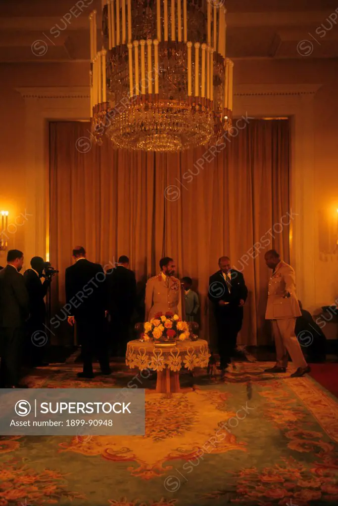 Hailè Selassiè. king of Ethiopia, in the royal palace, together with other political and military figures. Addis Abeba (Ethiopia), 1965.