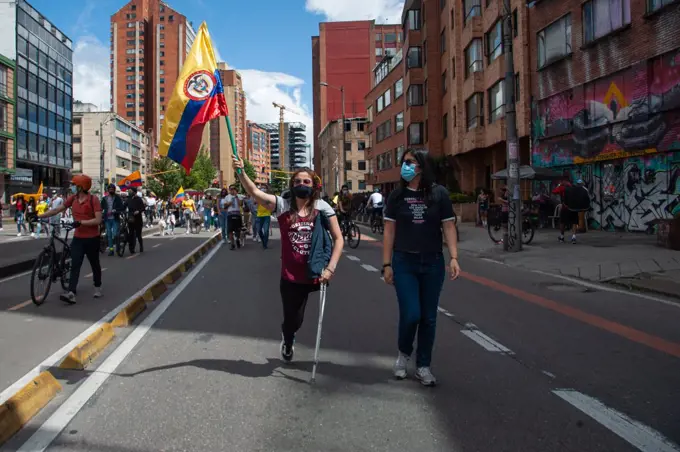 A handicapped woman without a leg, protests with a colombian flag in Bogota, Colombia on May 9 2021, as peaceful demonstrarions against police brutality had left at least 30 dead in the 12 days of Demonstrations in Colombia, as LGTB+ and Transgender community members participated in the protest.