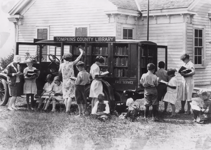 Rural schoolchildren crowd around a traveling book auto as they choose reading material, Tompkins County, NY, 1930. (Photo by G W  Ackerman/United States Department of Agriculture/GG Vintage Images)