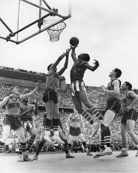 A member of the Harlem Globetrotters, the famous all-African-American US professional basketball team, goes up to score a lay-in shot during a game played against the Boston Celtics before a sell-out crowd in West Berlin. The Globetrotters made numerous overseas tours to perform before millions of sports enthusiasts the world over, West Berlin, Germany, 8/22/1951. (Photo by United States Information Agency/PhotoQuest/Getty Images)