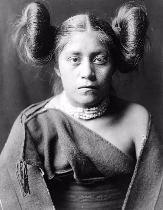 Edward S. Curits Native American Indians - A Tewa girl, hair arranged in 'squash blossom' fashion circa 1906.