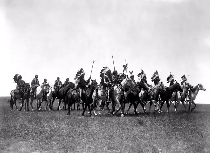 Edward S. Curtis Native American Indians - Brulé Indians, many wearing war bonnets, on horseback circa 1907.