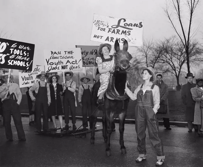 Anti-war protesters against World War II holding signs circa 1940 .