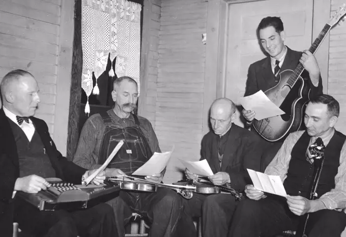 Bog Trotters Band members seated with instruments, Galax, Va. Includes Doc Davis, with autoharp; Crockett Ward, with fiddle; Uncle Alex Dunford, with fiddle; Wade Ward, with banjo; Fields Ward, with guitar circa 1937.