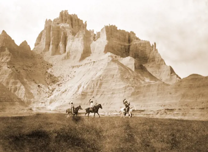 Edward S. Curtis Native American Indians - Entering the Bad Lands. Three Sioux Indians on horseback circa 1905.