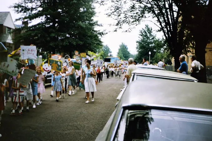 Children marching in an elementary school parade circa 1964.