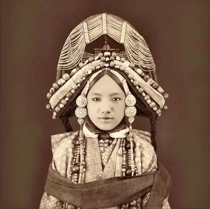 An early photograph by Sarat Chandra Das of a Tibetan priness (lhacham) wearing traditional clothing, heavy jewellery and a very elaborate headdress.