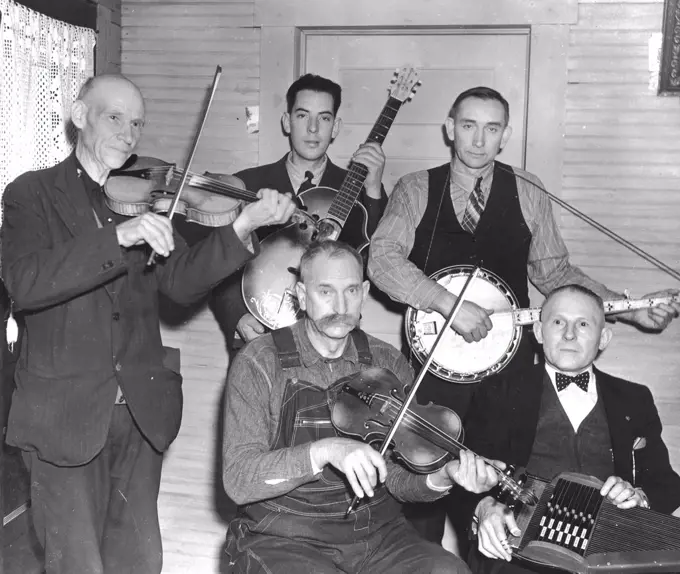 Members of the Bog Trotters Band, posed holding their instruments, Galax, Va. Back row: Uncle Alex Dunford, fiddle; Fields Ward, guitar; Wade Ward, banjo. Front row: Crockett Ward, fiddle; Doc Davis, autoharp circa 1937.