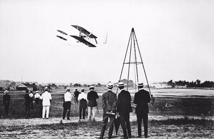 1909 - The Wright Brothers test fly their aircraft on Fort Myer's parade field. 