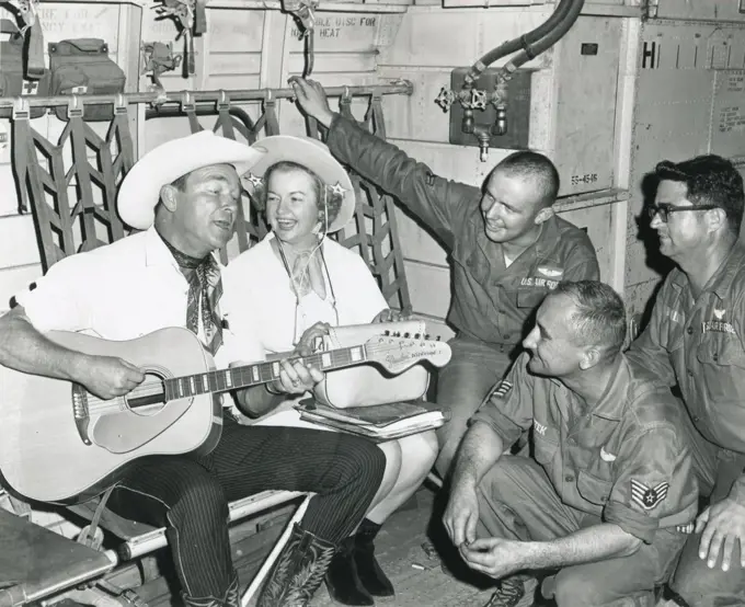 Roy Rogers and Dale Evans entertain crew members of an Air Force C-123 Provider during the last leg of their Vietnam tour. Crew members are (l-r) Airman 2nd Class Cyril F. Crawley, SSGT. Francis K Ssutek , and Tech Sgt Eddie Miller. Nov 1966. 