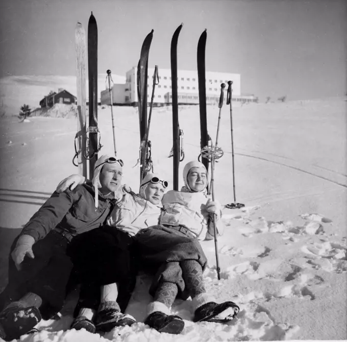Finland History -  Three skiers chilling on snow, enjoying the sun in front of Hotel Pallas. ca. 1938 . 