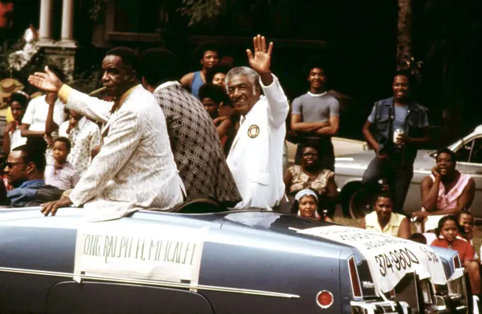 1973 - Illinois Congressman Ralph H. Metcalfe (White Coat) Greeting Constituents During The Bud Billiken Day Parade, 08/1973. 