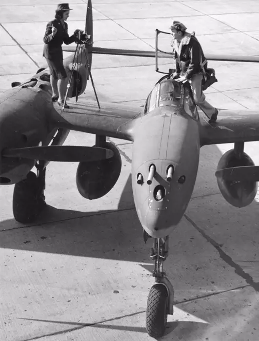 Photo Technician Sgt Virginia Hull photographs P-38 pilot Major Robert W. Springer. Sgt Hull is deft at developing and printing, as well as taking photos. 1943. 