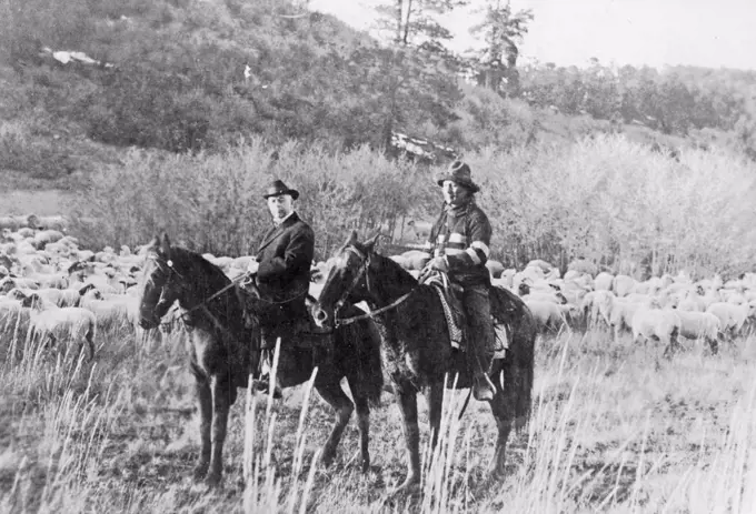 Edd Ladd, full-blood Apache Indian, of the Jicarilla Reservation, New Mexico, with Indian Commissioner Cato Sells, on horseback ca. 1909.