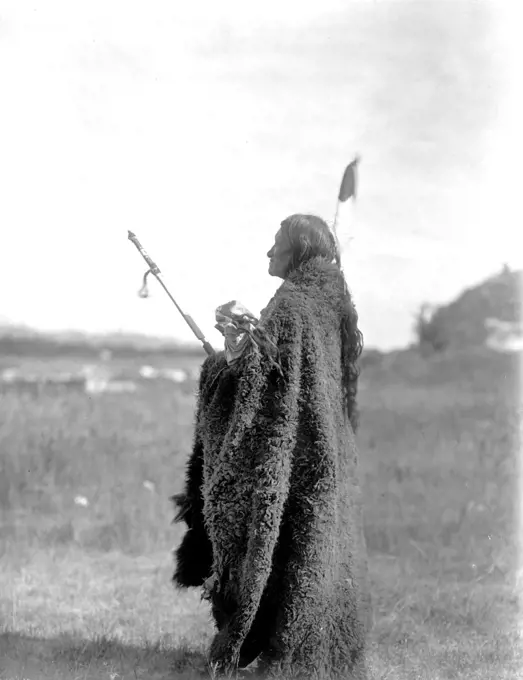 Edward S. Curits Native American Indians - Photograph shows Saliva, an Oglala Sioux priest, dressed for the Hu Kalowa Pi ceremony ca. 1907. 