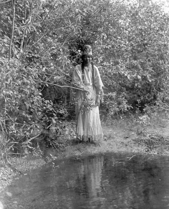 Edward S. Curtis Native American Indians -  Nespelim woman standing at water's edge ca. 1905. 